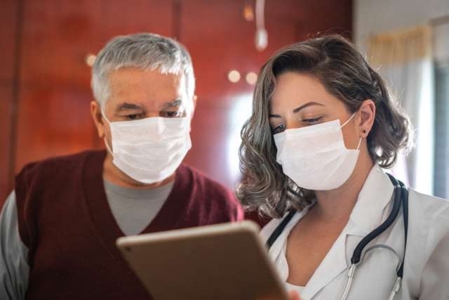 Patient and doctor looking at tablet