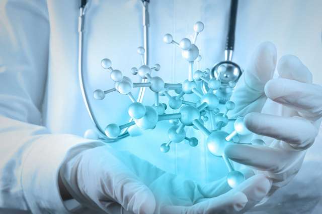 Molecule structure hologram floating above hands of doctor
