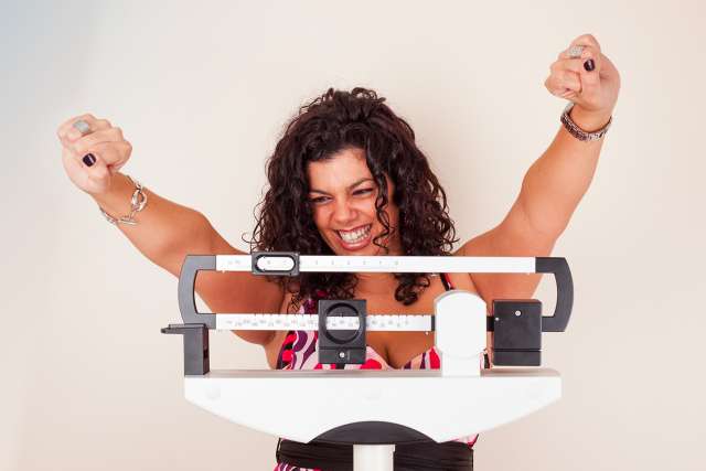 Woman happy with scale measurements