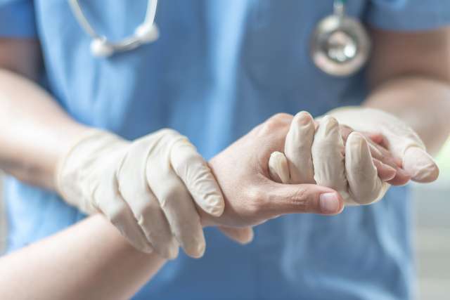 Doctor holding patient’s hand