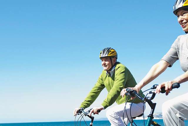 Couple bicycling on beach