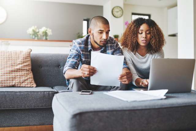 Two people at home in front of laptop
