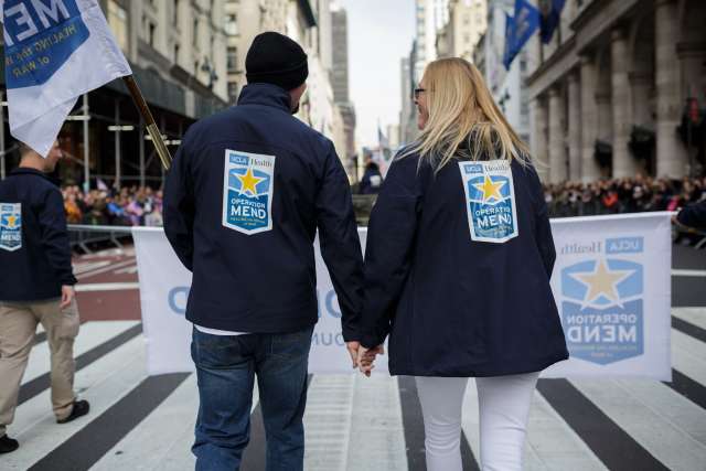 Two Operation Mend supporters holding hands