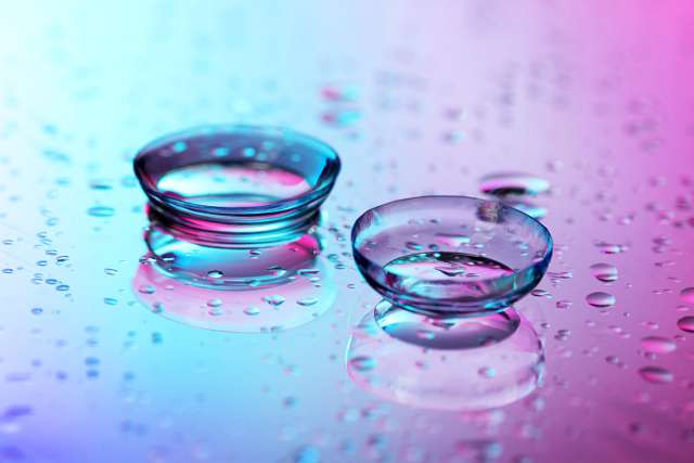 Contact lenses on blue-magenta background