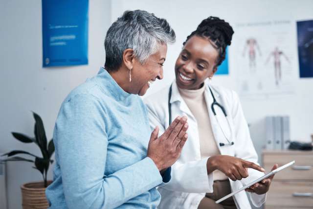African American female doctor with a cancer patient during a clinic visit