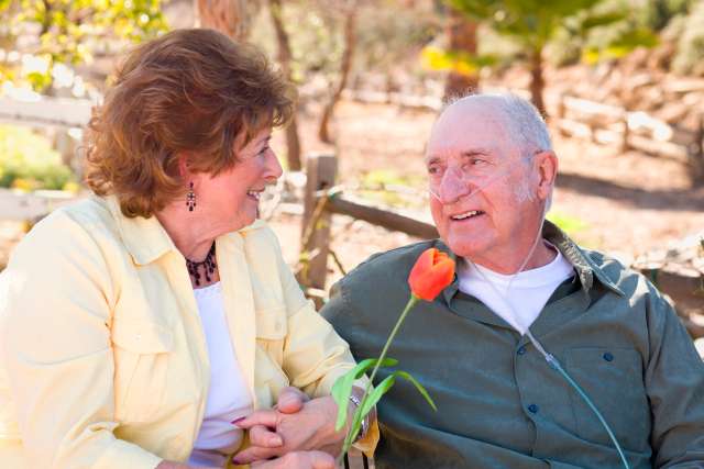 Man wearing Oxygen, sitting in the park
