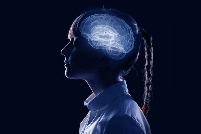 Side view of girl with brain illustration