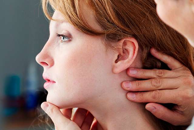 Doctor examining woman’s face
