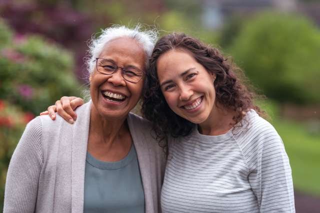 Mom and daughter hugging and smiling