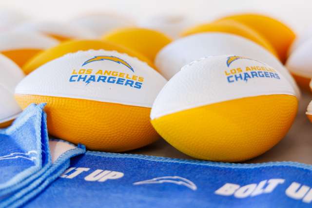 Football balls with the Los Angeles Chargers logo and color on them