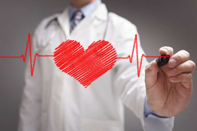 man drawing heart on board