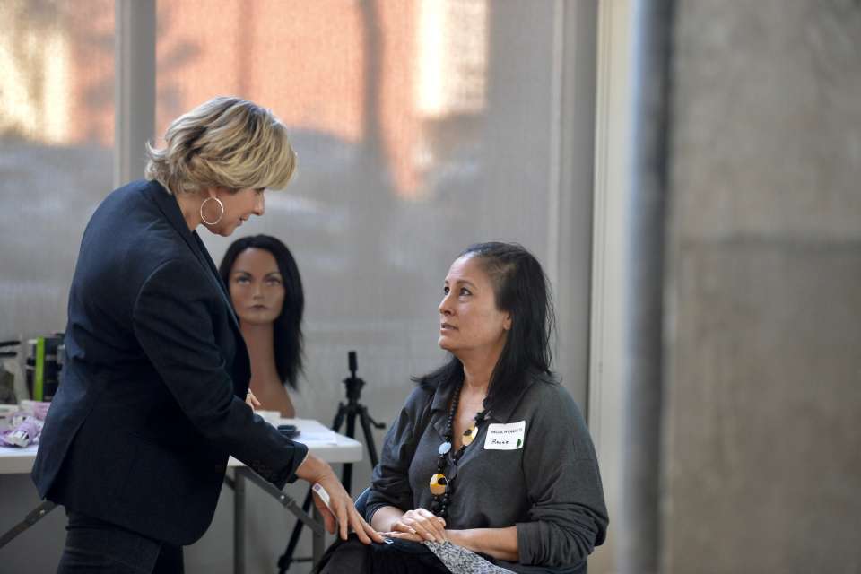 Hairstylist Jerilynn Stephens, left, visits with clinic attendee Renee Leonhardt. (Photo courtesy of Rachel Frankenthal)