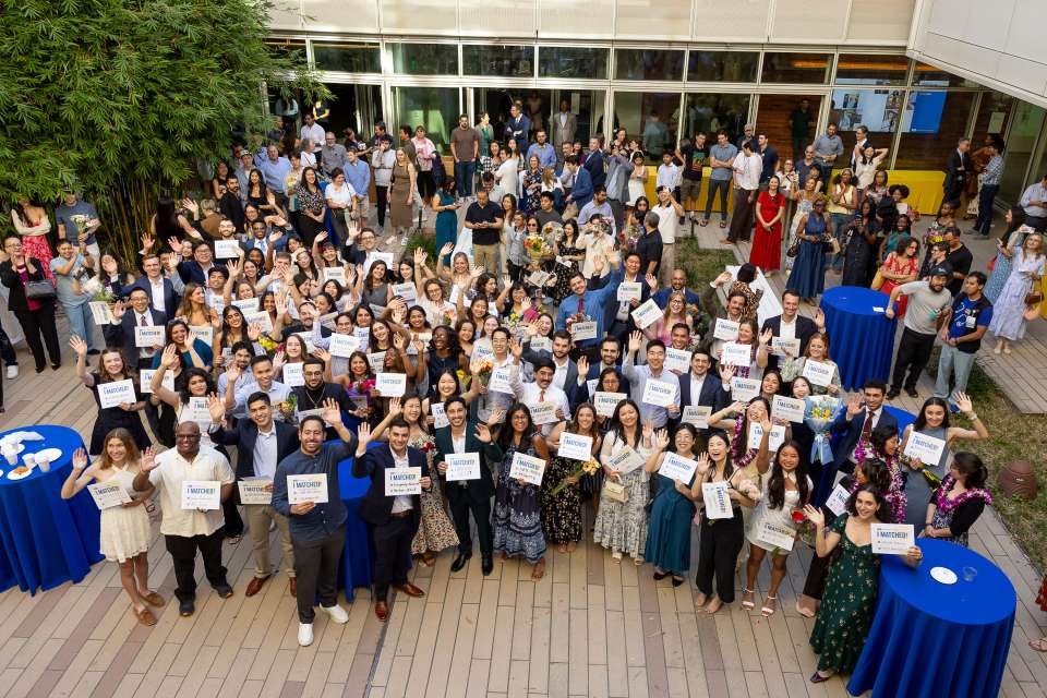 The David Geffen School of Medicine at UCLA class of 2026 holds up their Match Day cards at Geffen Hall at UCLA.