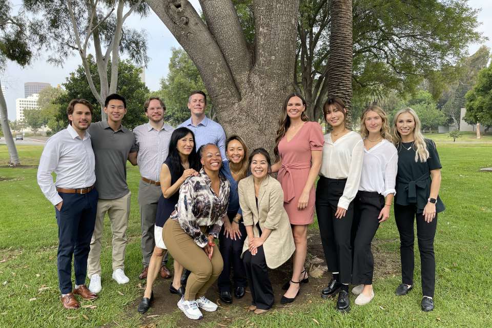 group of 12 residents of the PM and R program outside near a tree
