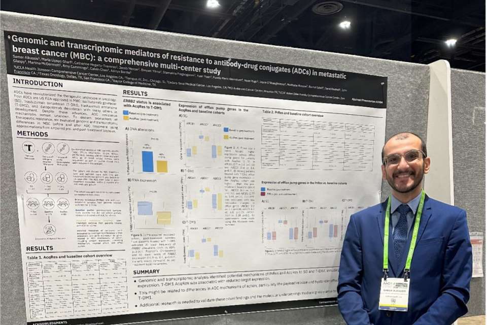 Samer Alkassis standing in front of his research poster 