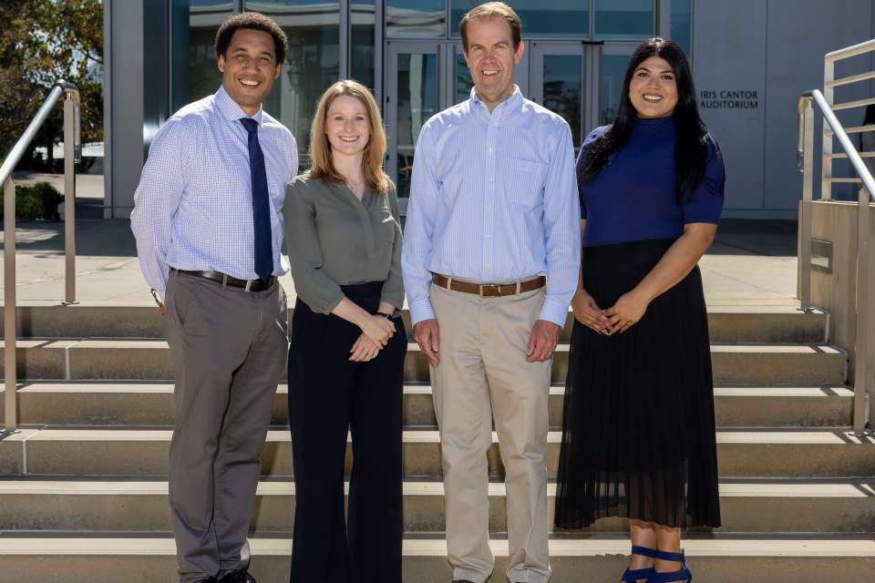 A group photo of the Laboratory Stewardship team on stairs in front of Geffen Hall