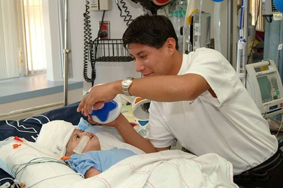 Doctor and one of the Maria twins after surgery
