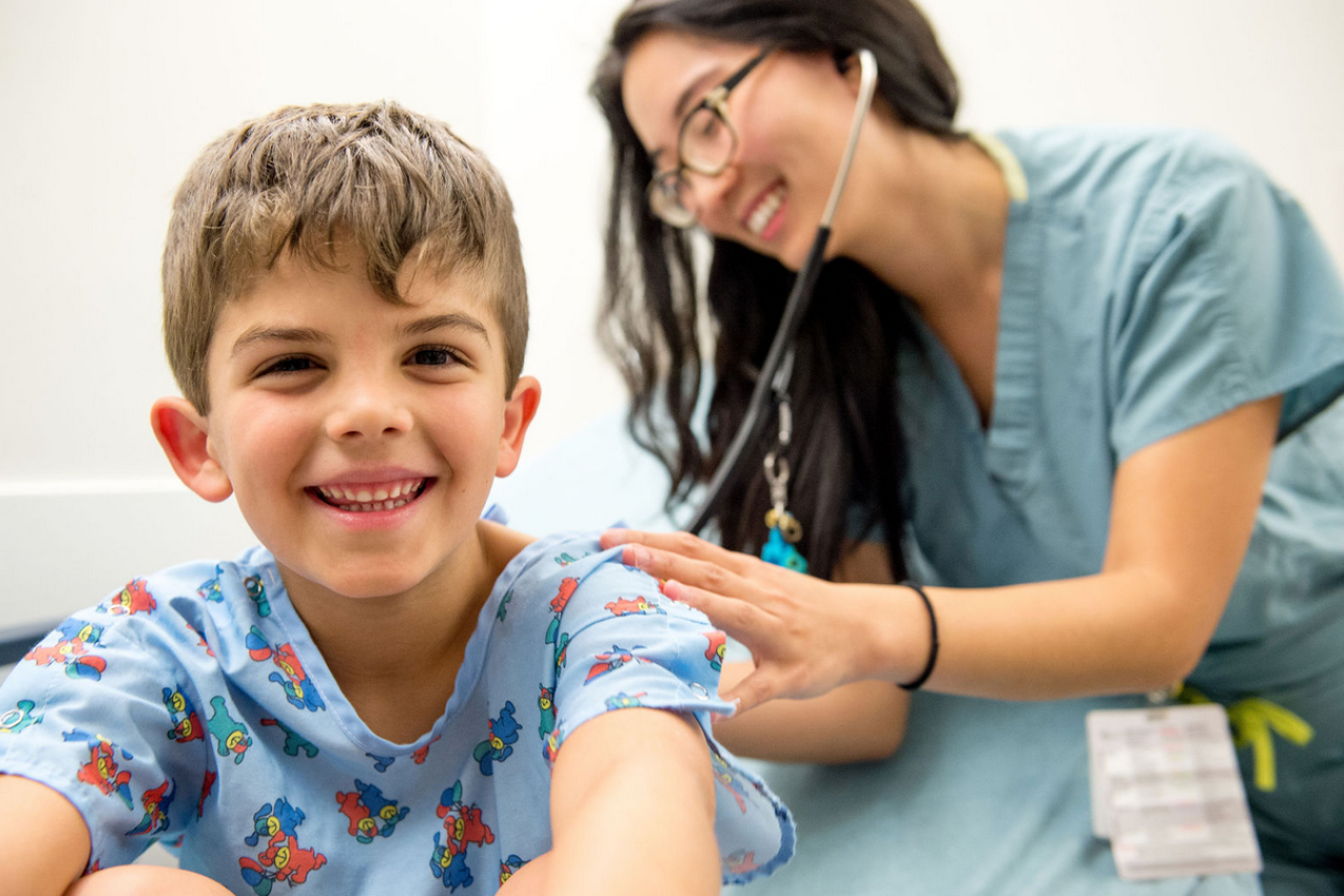 A young patient and a nurse with a stethoscope.