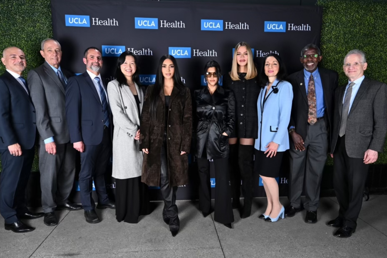 Kim, Khloé, and Kourtney Kardashian posing with UCLA Health physicians at the Robert G. Kardashian Center for Esophageal Health.