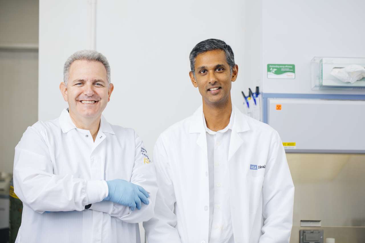 Bennett Novitch and Dr. Ranmal Samarasinghe stand in a lab.