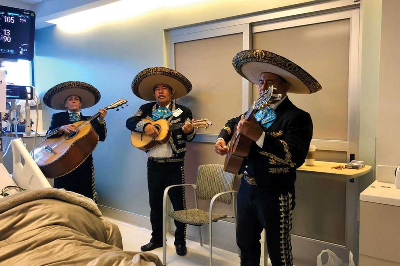 Mariachi band performing inside hospital room