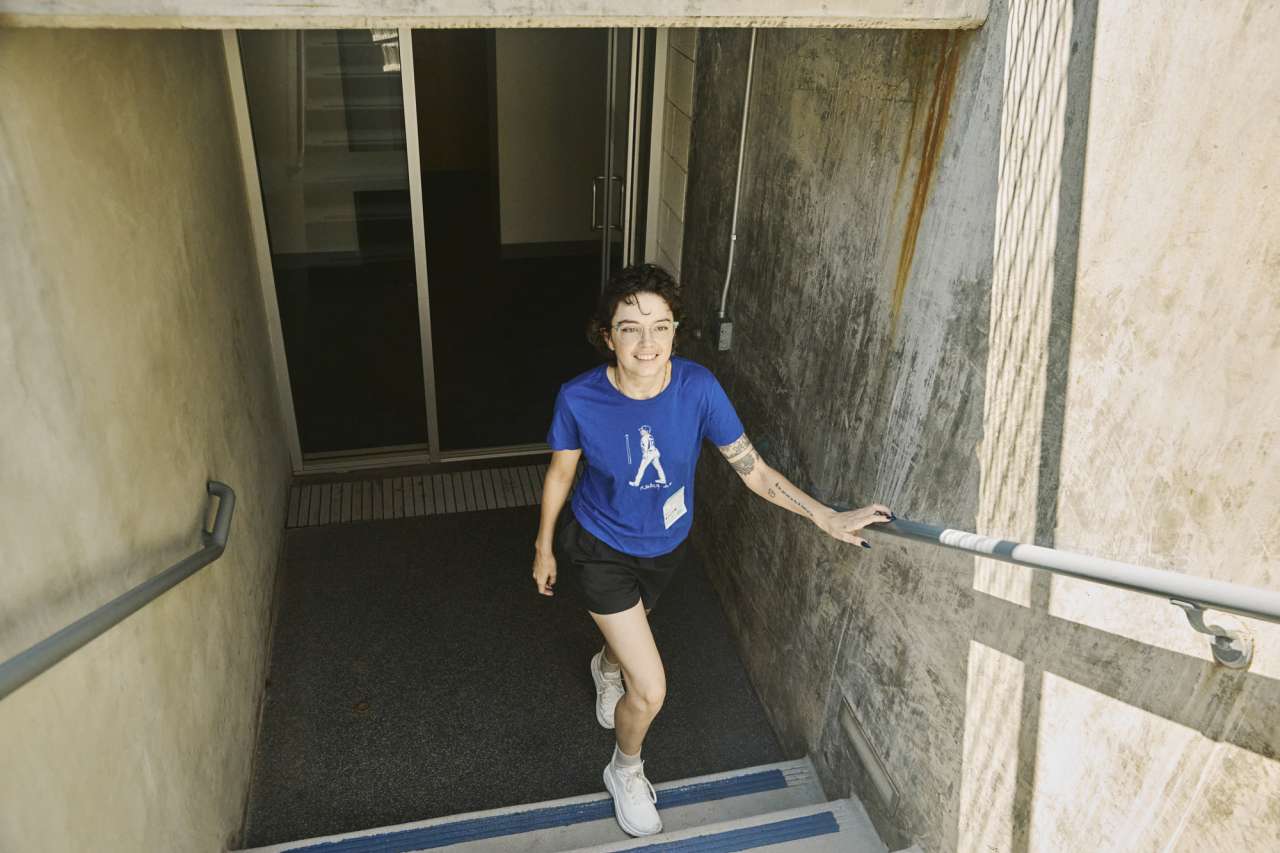 A woman walks up stairs at Dodger Stadium.