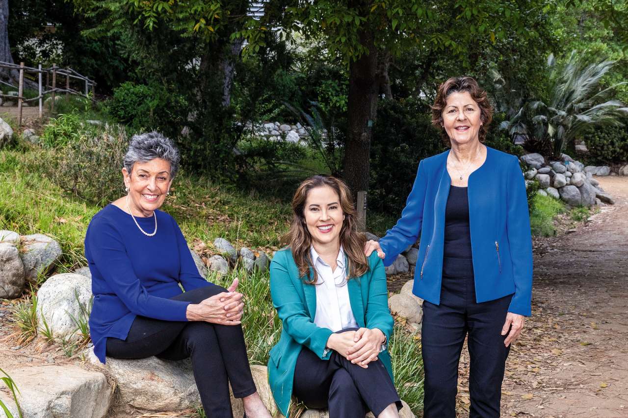 Drs. Vivien K. Burt, Misty Richards and Michelle G. Craske sitting on the stair steps. They're leaders at UCLA Health in the treatment of mothers with postpartum depression.