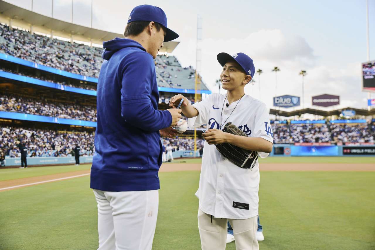 A teen oncology patient and a Dodgers star on the field at Dodger Stadium.