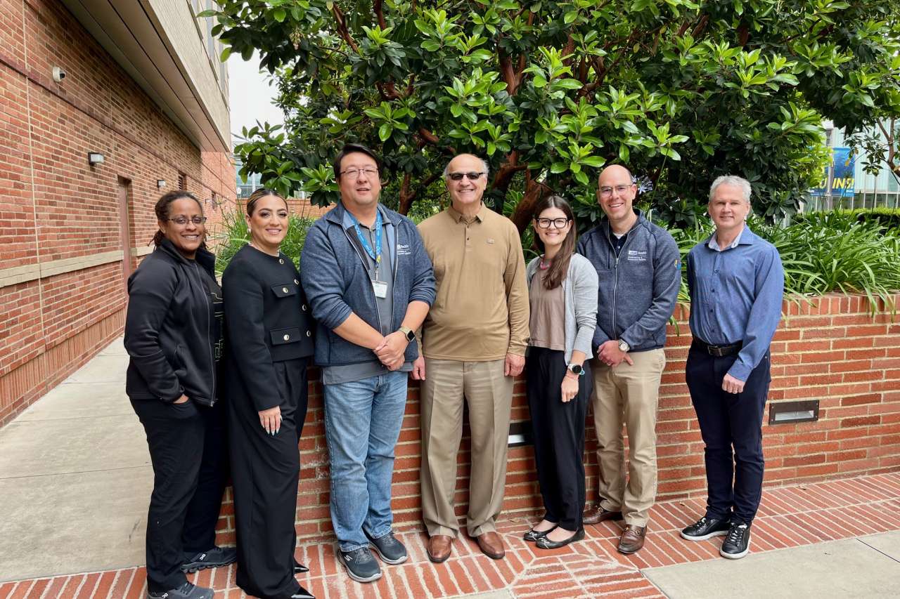 Seven fellowship members standing next to each other during UCLA Bioinformatics & Perioperative Analytics Retreat 2024 