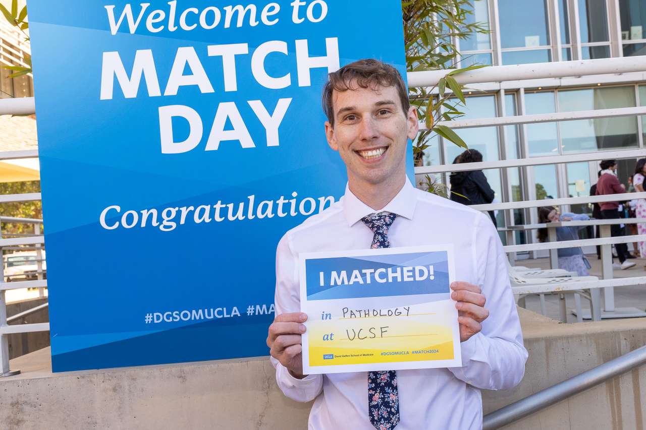 Samuel Hulbert holding an I matched sign for UCSF pathology.