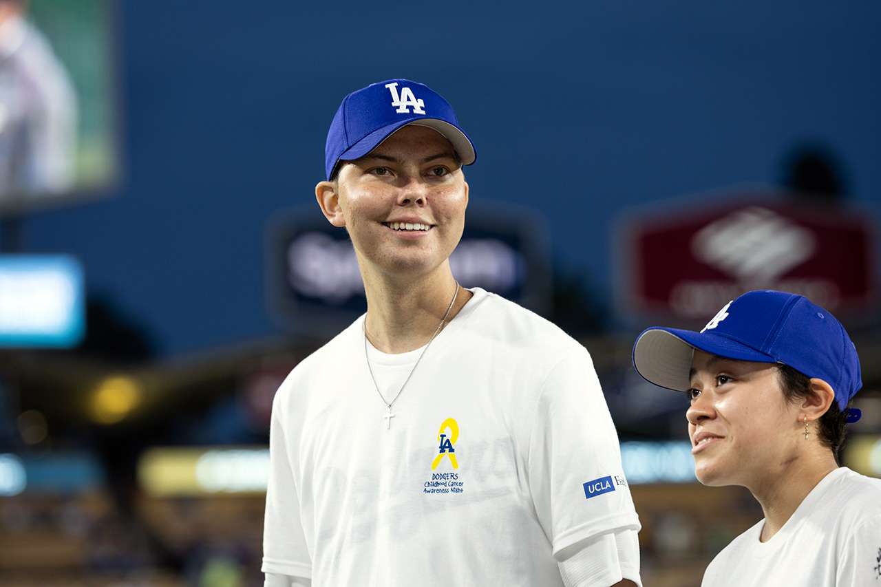 A young cancer patient takes in the thrill of being on the field at Dodger Stadium.