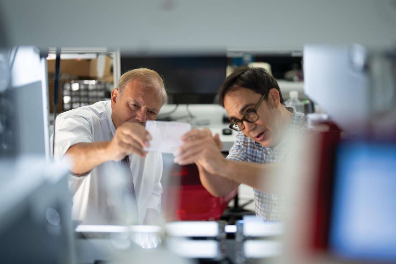 Dr. Dennis Slamon holds up cells in his lab