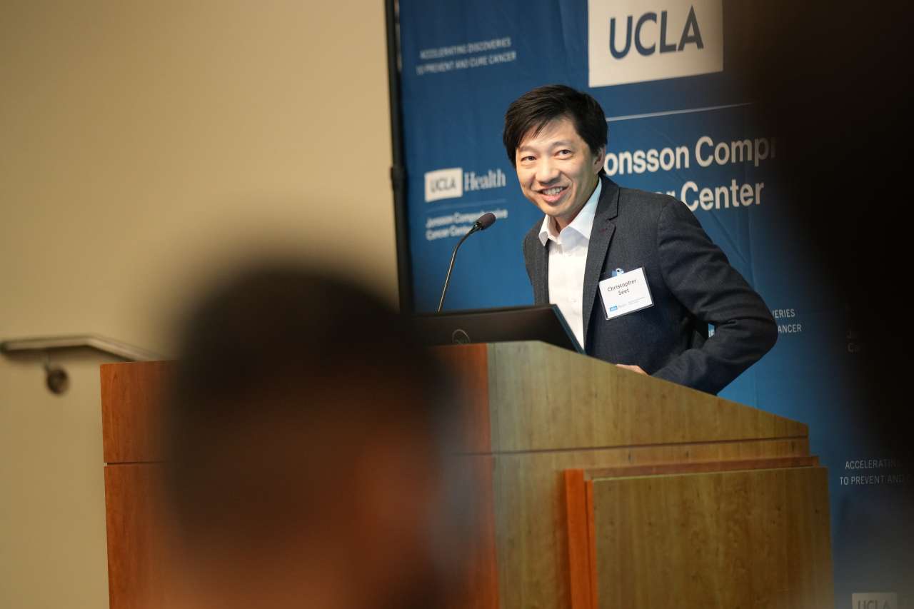 Christopher Seet speaking at a podium.