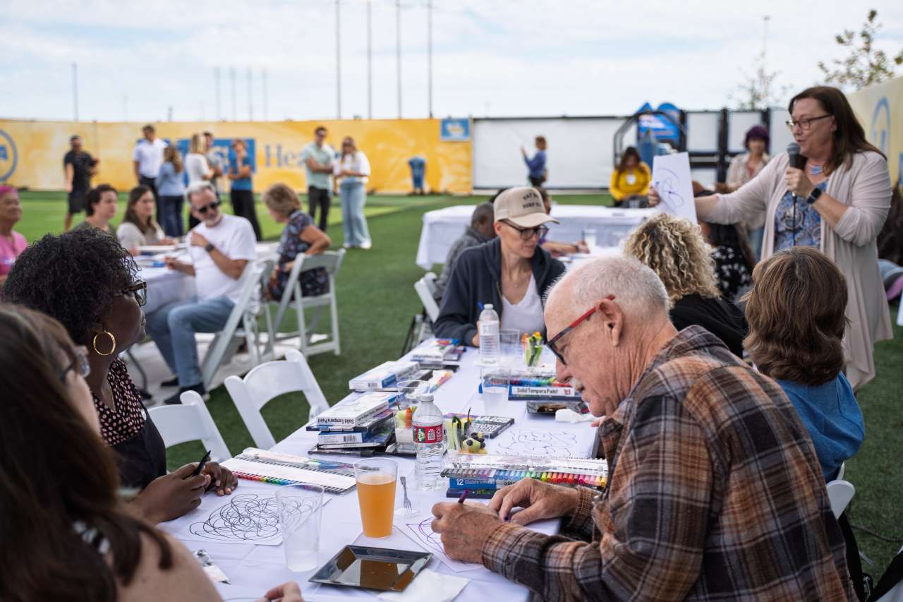 Dr. Paige Asawa, right, works with guests.