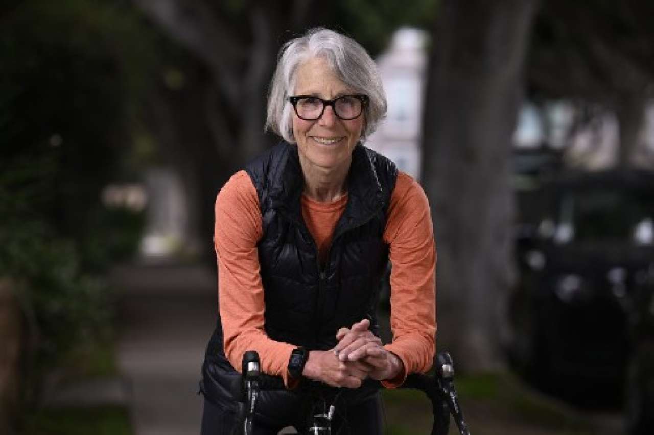 Jill Weisman resting on her bike