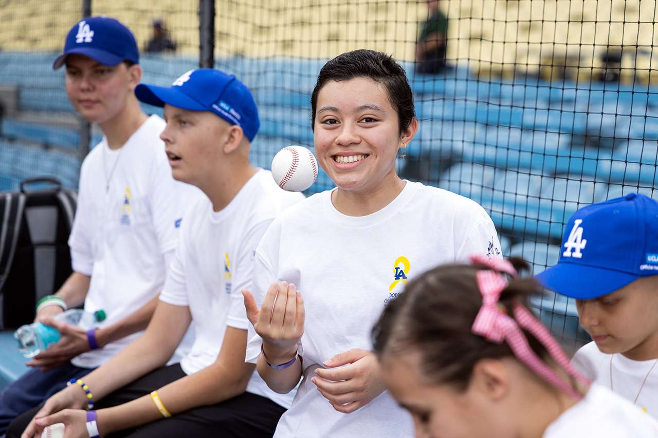 Andrea Altamirano tosses up a baseball at Dodger Stadium