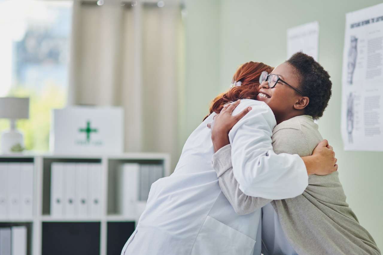 Doctor and patient hug during an art therapy class