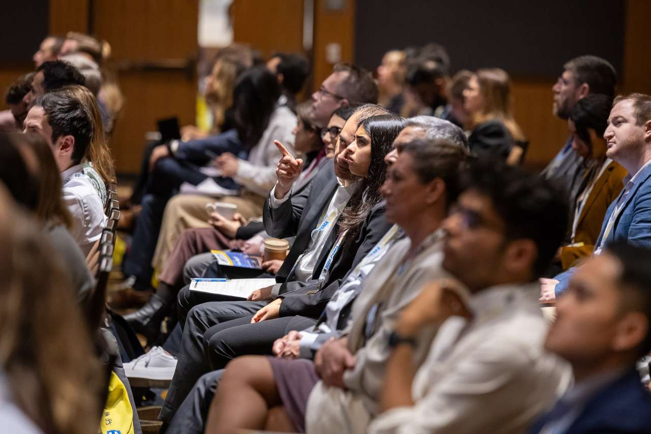 Audience members attentively listening at a conference or seminar.