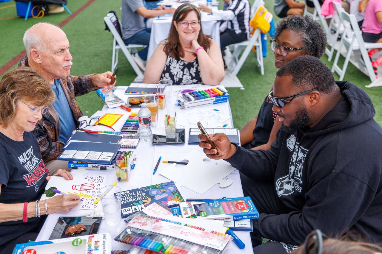 Chargers player Teair Tart, right, with Crucial Catch guests.