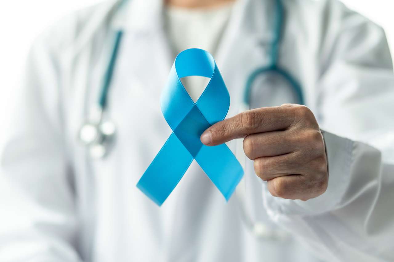 Doctor holding a cancer ribbon