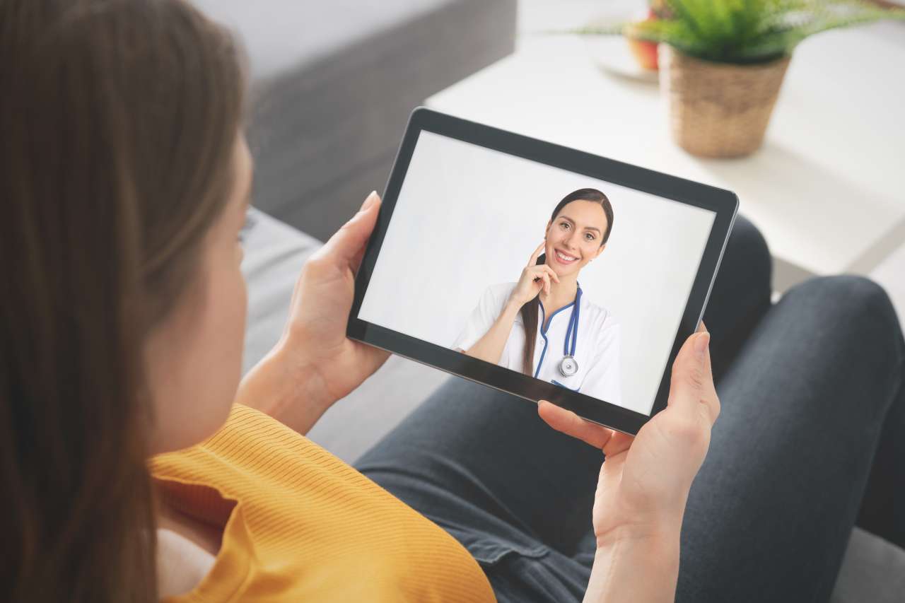 Woman viewing doctor on tablet