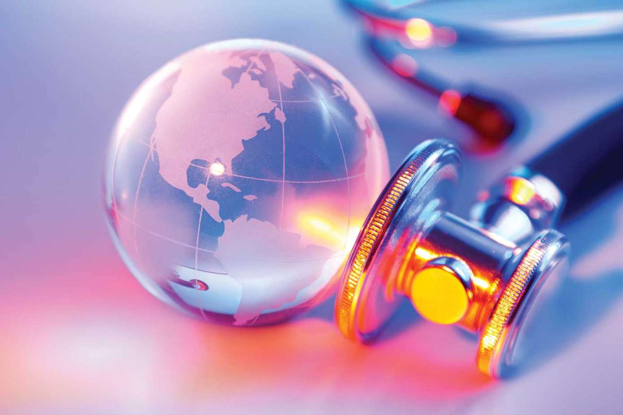 Stethoscope and glass globe on table top