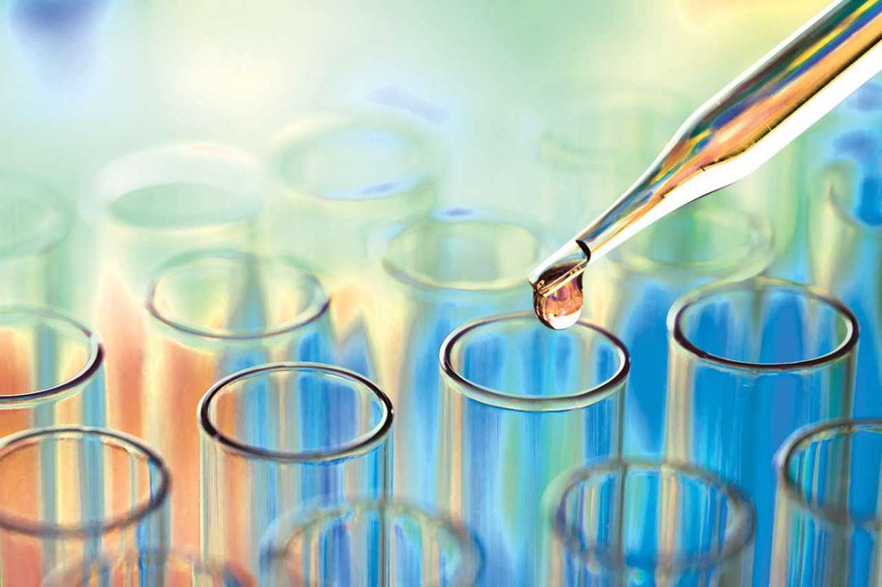 Colorful light refracting on test tube rack and dropper