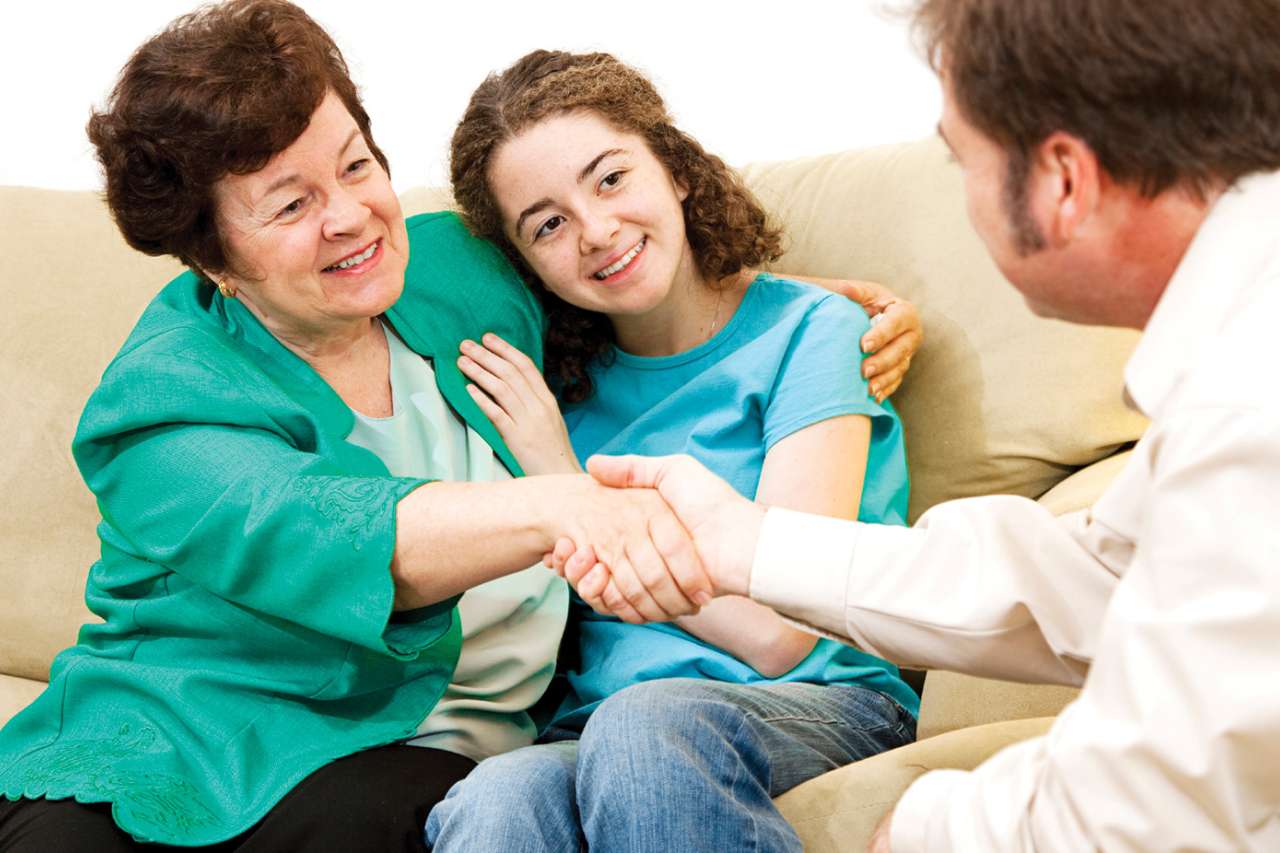 Mother and daughter speaking with doctor
