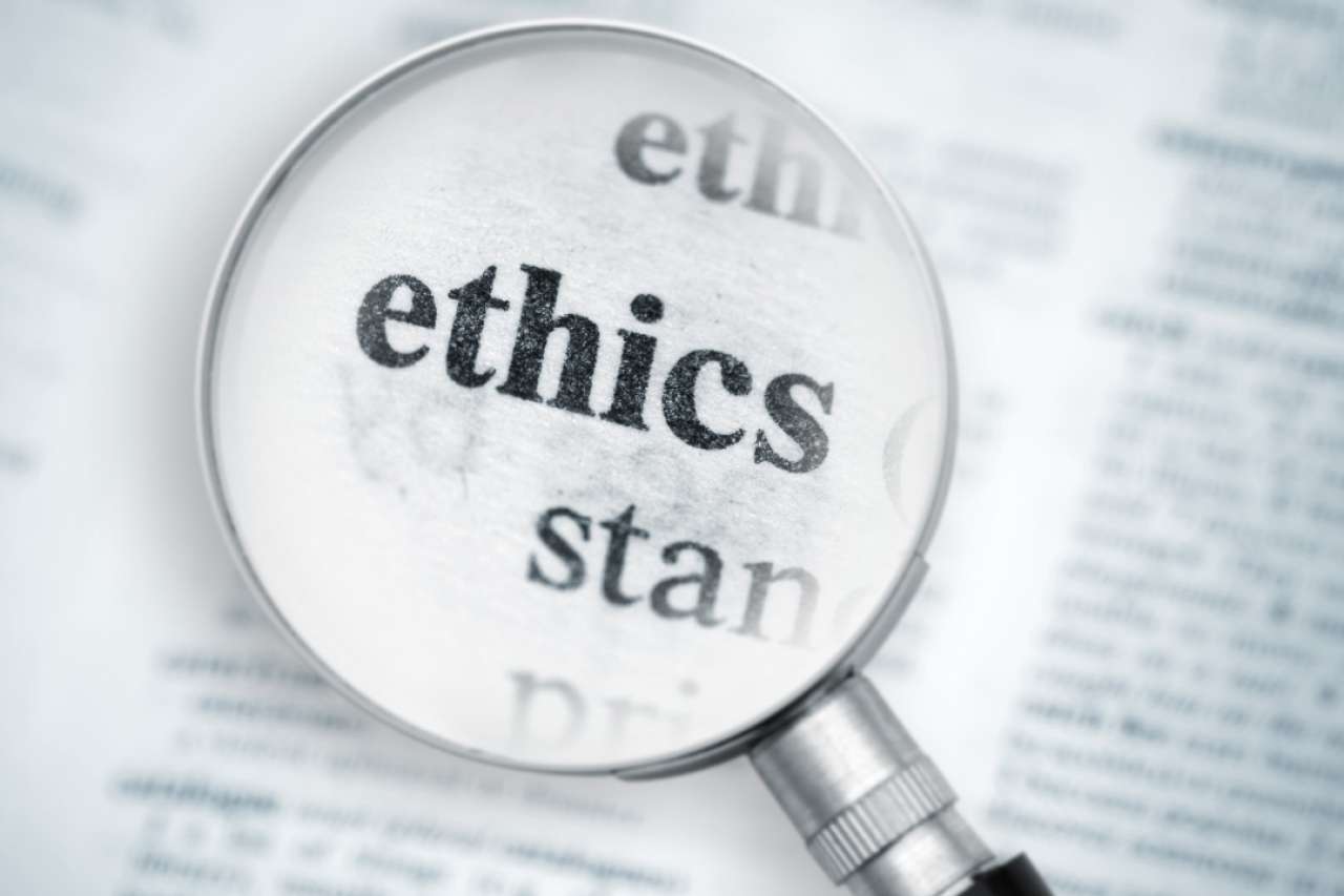 Magnifying glass over the word "ethics"