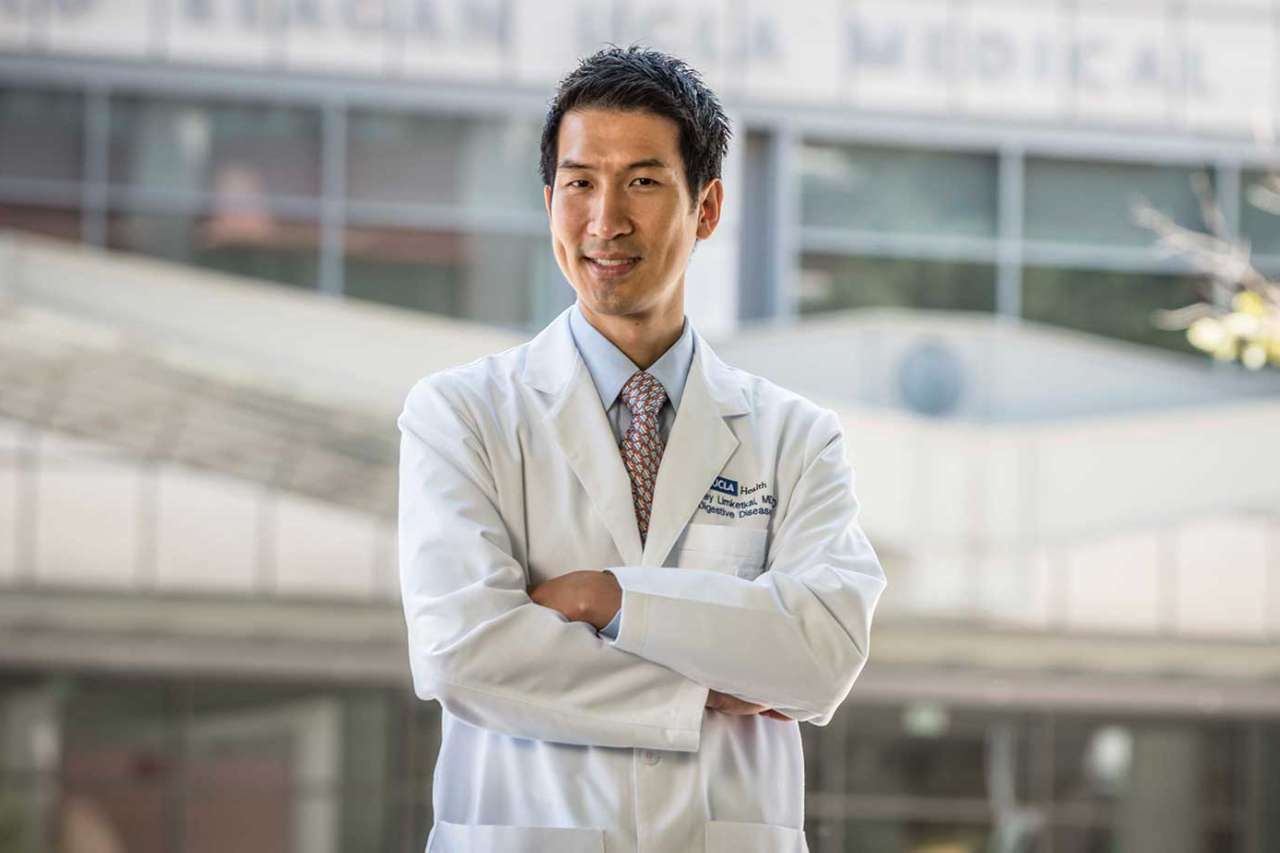 Dr. Limketkai standing in front of Ronald Reagan UCLA Medical Center