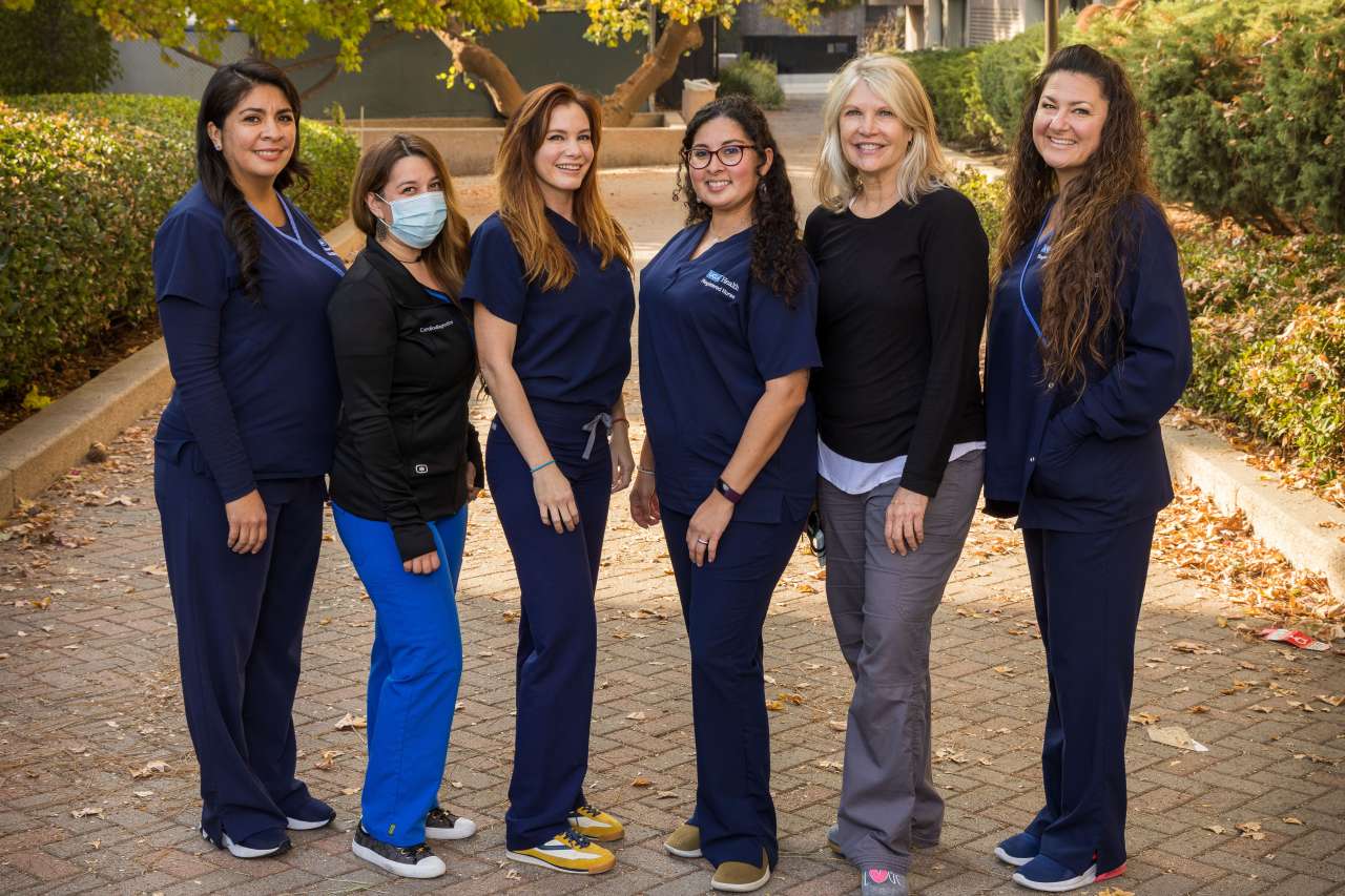 Group of nurses standing together smiling outdoors