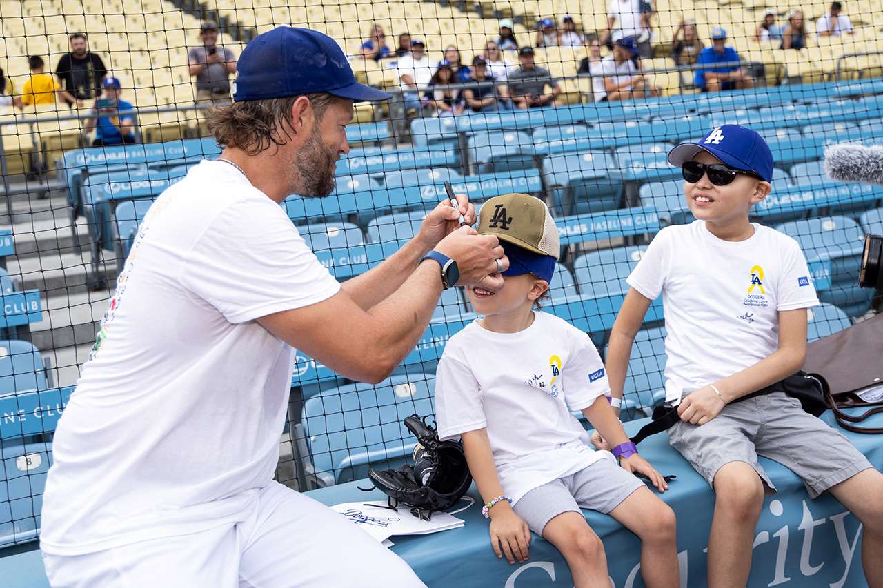 Clayton Kershaw visits with two young guests