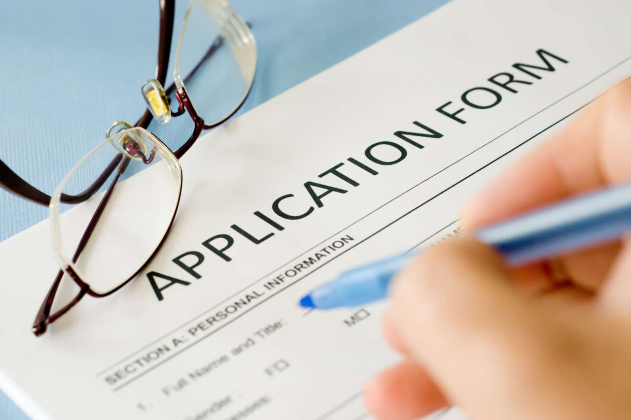 Person filling out an application form