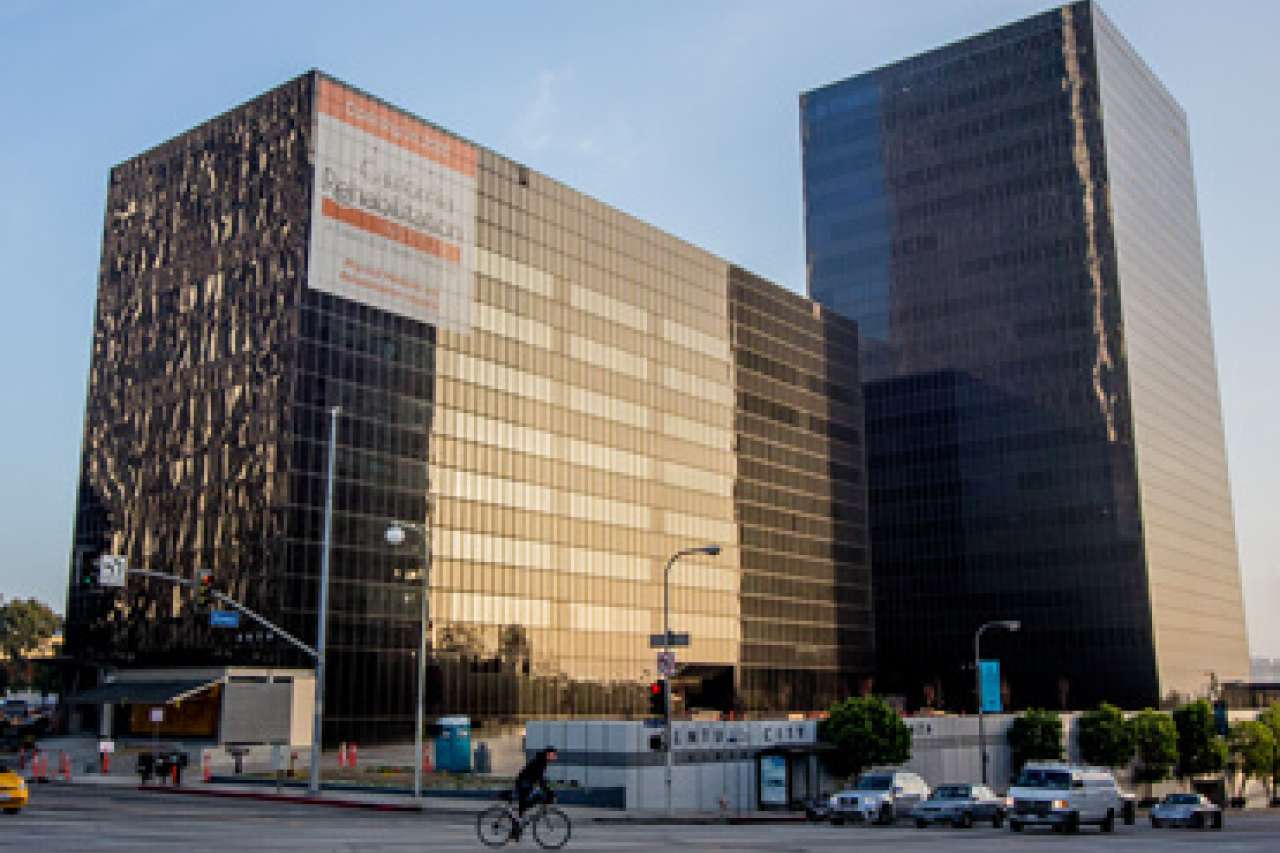 exterior of a dark building in daylight with a blue sky